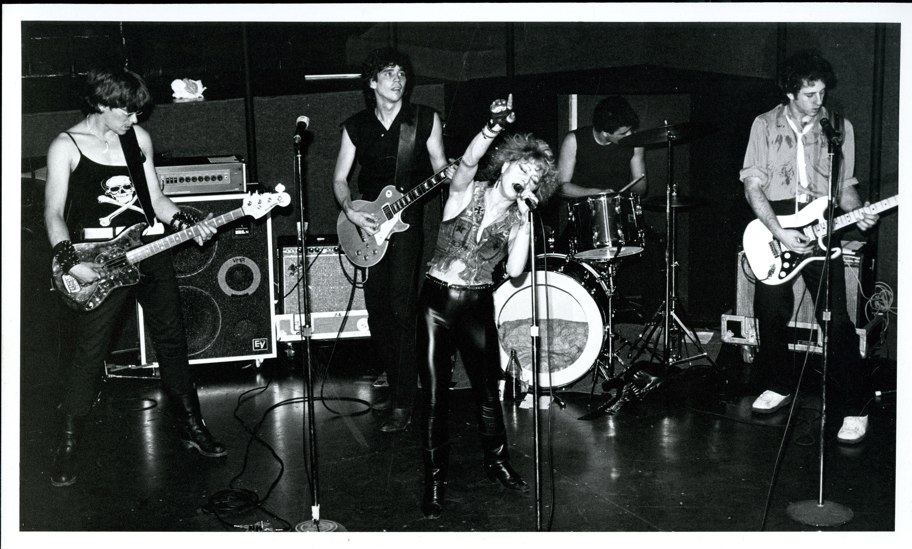 woman in leather vest fronting a band